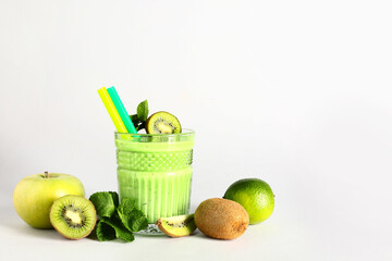 Glass of fresh kiwi smoothie with mint on white background