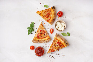 Pieces of tasty pizza Margarita with basil and bowl of mozzarella on white background