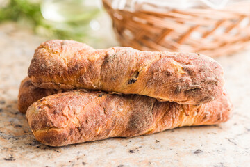 Crusty rustic baguette on kitchen table.