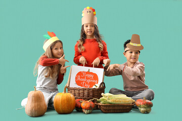 Cute little children with pumpkins on green background. Thanksgiving Day celebration