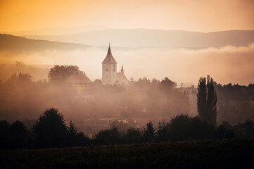 Tranquil Autumn Morning, A Rural Church Silhouette in the Mist