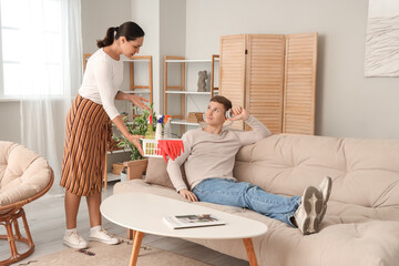 Wife asking her lazy husband to clean up at home