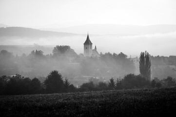 A Church Towering Over the Autumn Mist. Black and white photo