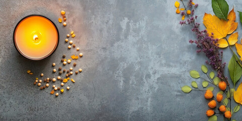 Candle and autumn leaves on textured background