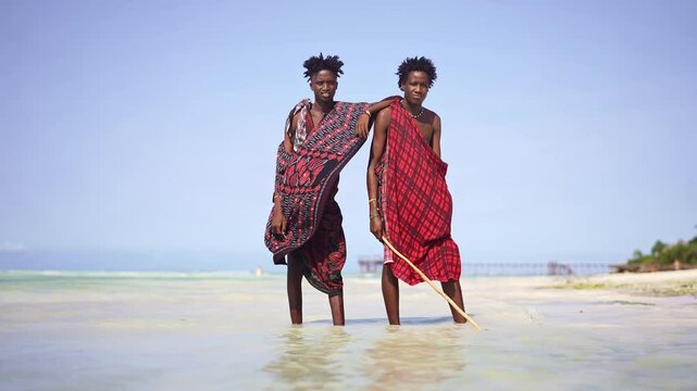 Portrait of Maasai man, traditional outfit, African warrior tribesman on beach. Tropical island beach in Tanzania. tourism destination in Africa. 
