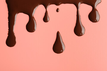 Sweet chocolate splashes on red background