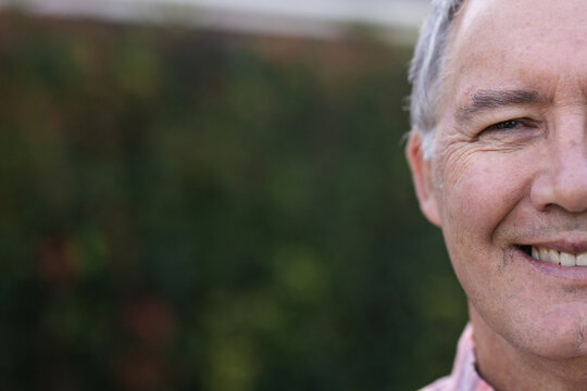 Smiling senior man outdoors, showing happiness and positive attitude in nature, copy space, at home