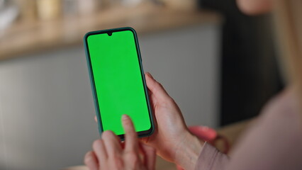 Girl scrolling mockup mobile phone making online order at home kitchen close up.