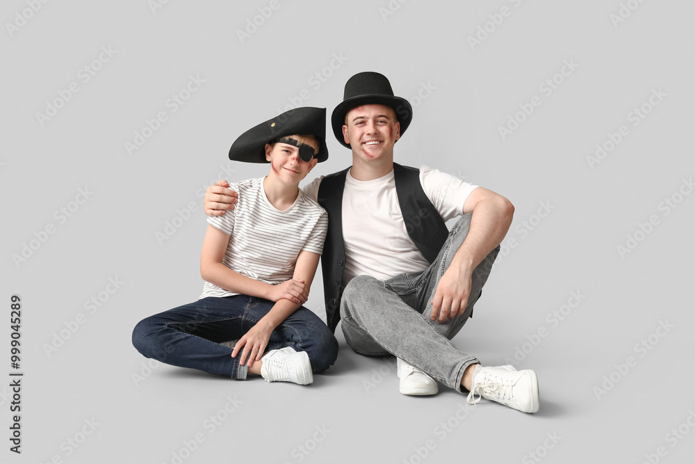 Canvas Prints Father with his son dressed for Halloween sitting on light background