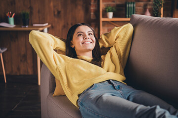 Obraz premium Photo portrait of attractive teen woman lying sofa have rest sleepy dressed yellow outfit cozy day light home interior living room
