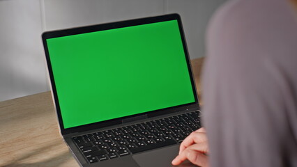 Unrecognizable student studying greenscreen laptop sitting home close up.