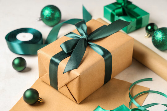 Christmas gift boxes with packing materials and decorations on white background