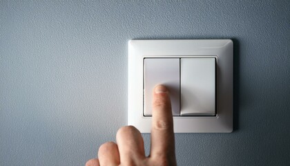 finger pressing a switch, a person reaches out to press the room light switch