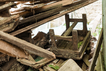 Abandoned Wooden Cart Hidden Amongst Weathered Planks in a Forgotten Shed