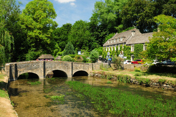 Idyllic Coln River In Bibury Cotswolds England Great Britain On A Beautiful Summer Day With A Clear Blue Sky