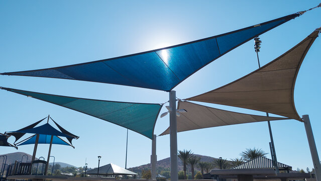 Colorful sail shades over picnic tables at a public park