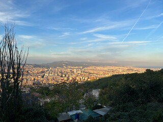 Barcelona Cityscape from Above at Dusk: A panoramic view of Barcelona’s urban sprawl and distant...