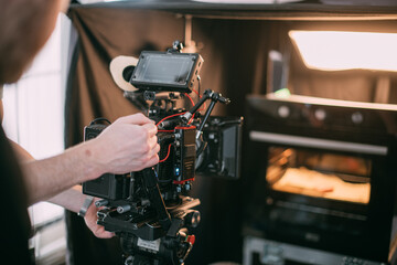 Professional cinema and video camera on the set. Shooting shift, lighting fixtures, shooting equipment and the team.