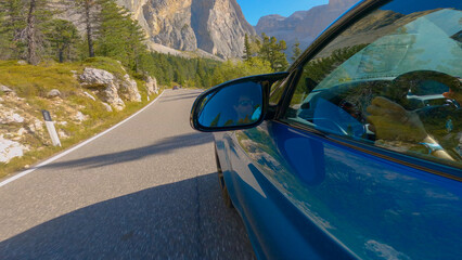 CLOSE UP: Thrill-seeking Caucasian man races his brand new luxury sportscar in the sunny summer...