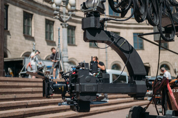 Professional film and video camera on a telescopic cinema crane on the set.