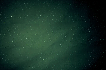 A green background with a lot of small dots