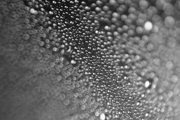 Macro shot of water droplet on reflective surface as background