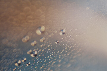 Macro shot of water droplet on reflective surface as background