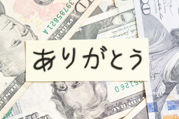Handwritten thank you note in Japanese on American banknotes. Thank you for the money