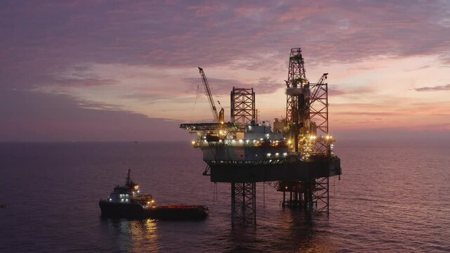 Aerial view of an offshore jack up drilling rig during sunset - oil and gas upstream industry
