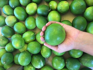 Fresh Limes at Brazilian Market Fair – Vibrant Citrus in Traditional Setting