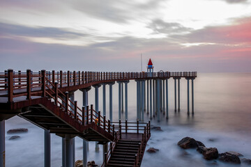 Bug-gu, Pohang-si, Gyeongsangbuk-do, South Korea - September 15, 2020: Sunrise and long exposure view of wave and sea rocks at Igari Anchor Observatory