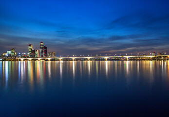 Yeouido, Yeongdeungpo-gu, Seoul, South Korea - September 21, 2020: Sunset and night view Han River with 63 building, Park One financial district and Wonhyo Bridge in the background