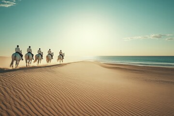people riding horses on a beach at sunset
