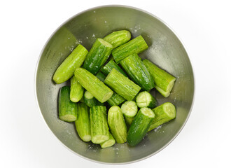 Raw cucumbers cut into pieces and sheathed with salt in a stainless bowl for the preparation of cucumber pickle, South Korea