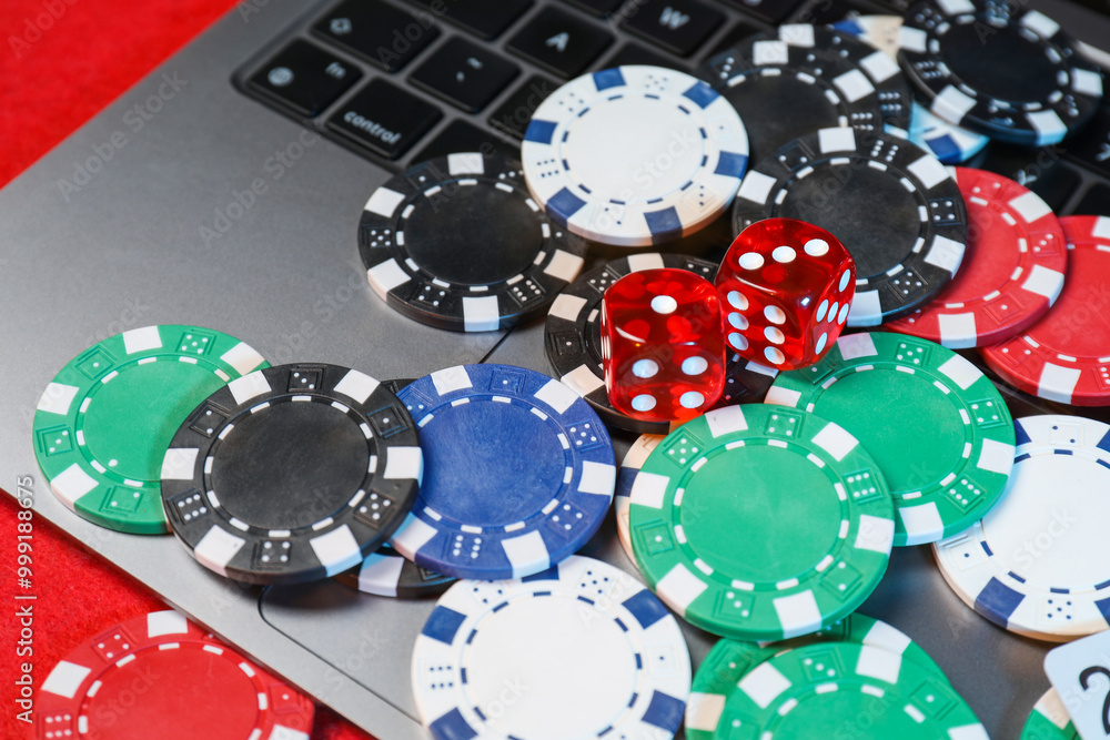 Poster Poker chips, laptop and dices on red table, closeup. Online game