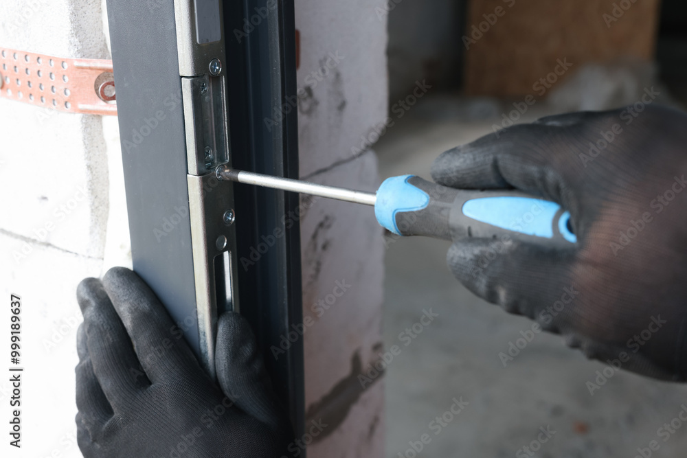 Sticker Repairman installing new door with screwdriver indoors, closeup