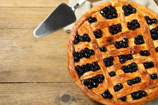 Tasty homemade pie with blueberries served on wooden table, flat lay. Space for text