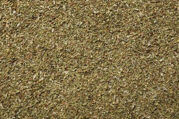 Obraz premium Dried oregano as background, top view. Aromatic herb