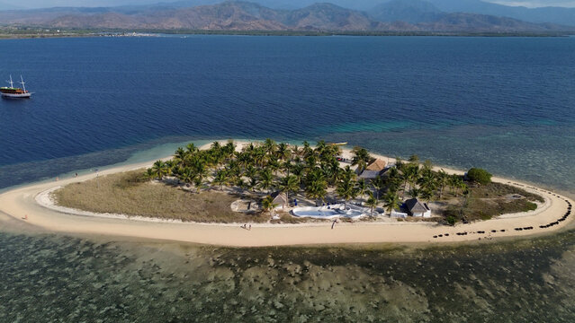 Small island Pulau Bedil, tropical island in Indonesia. Drone view.