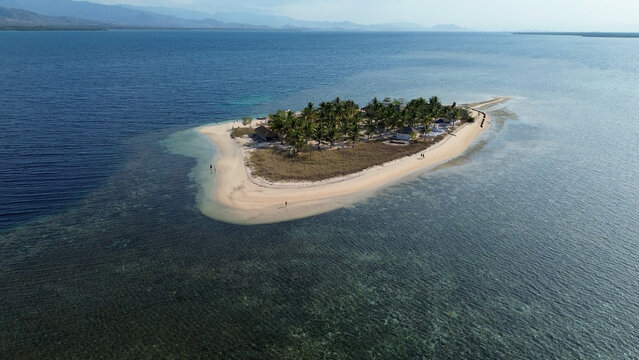 Small island Pulau Bedil, tropical island in Indonesia. Drone view.