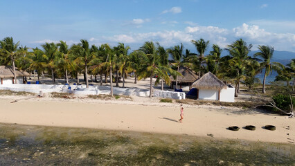 Small island Pulau Bedil, tropical island in Indonesia. Drone view.