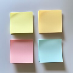 Fototapeta premium Assorted colored sticky notes on a plain background