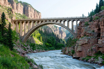 A stunning arch bridge spans a river, surrounded by lush greenery and towering cliffs, showcasing natural beauty and engineering.