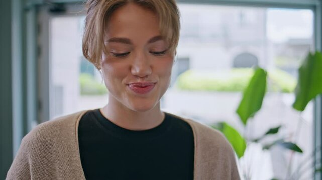 Closeup smiling woman talking to unknown interlocutor indoors. Young lady 