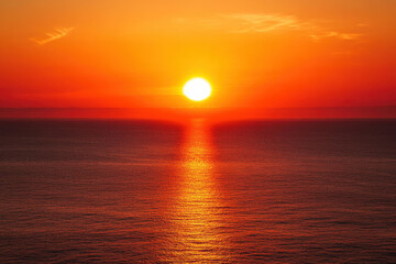 A stunning sunset over the ocean with vibrant orange and red hues filling the sky and reflecting on the water.