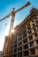 Hoisting crane,  Construction at building site with crane.