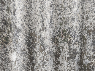 The close-up texture of the Asbestos surface is rough and weathered with cracked and damaged patterns in shades of gray and white. The natural and irregular design resembles abstract art. 