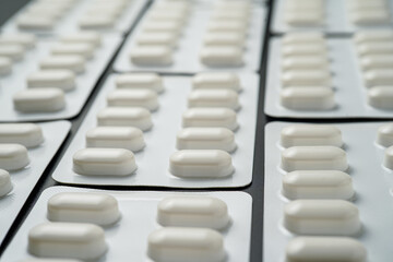 Pills Medicine tablet capsules in blister pack on a black background