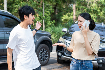 Asian man and woman drivers arguing after traffic collision accident feeling serious and stressed....