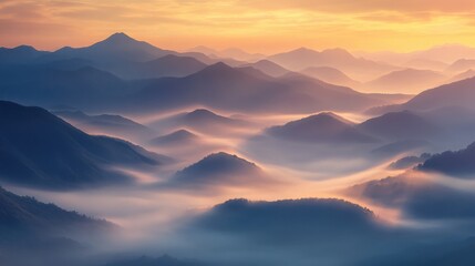  mist rolling over mountain peaks at sunrise